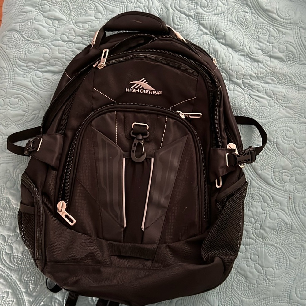 NWOT High Sierra backpack. Four large compartments, one padded for a laptop.